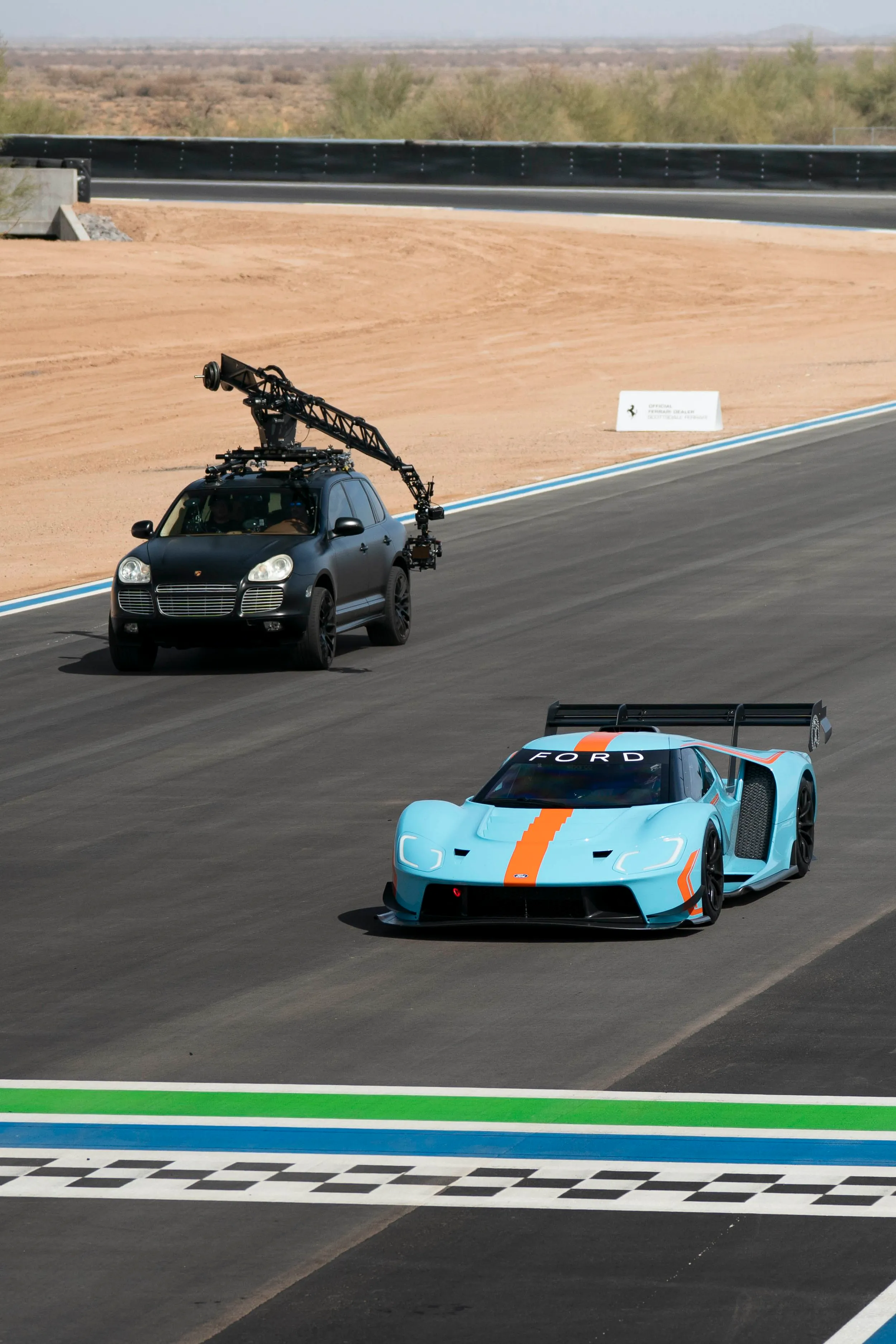 MotoCrane arm car tracking a Gulf-liveried Ford GT race car on a road course